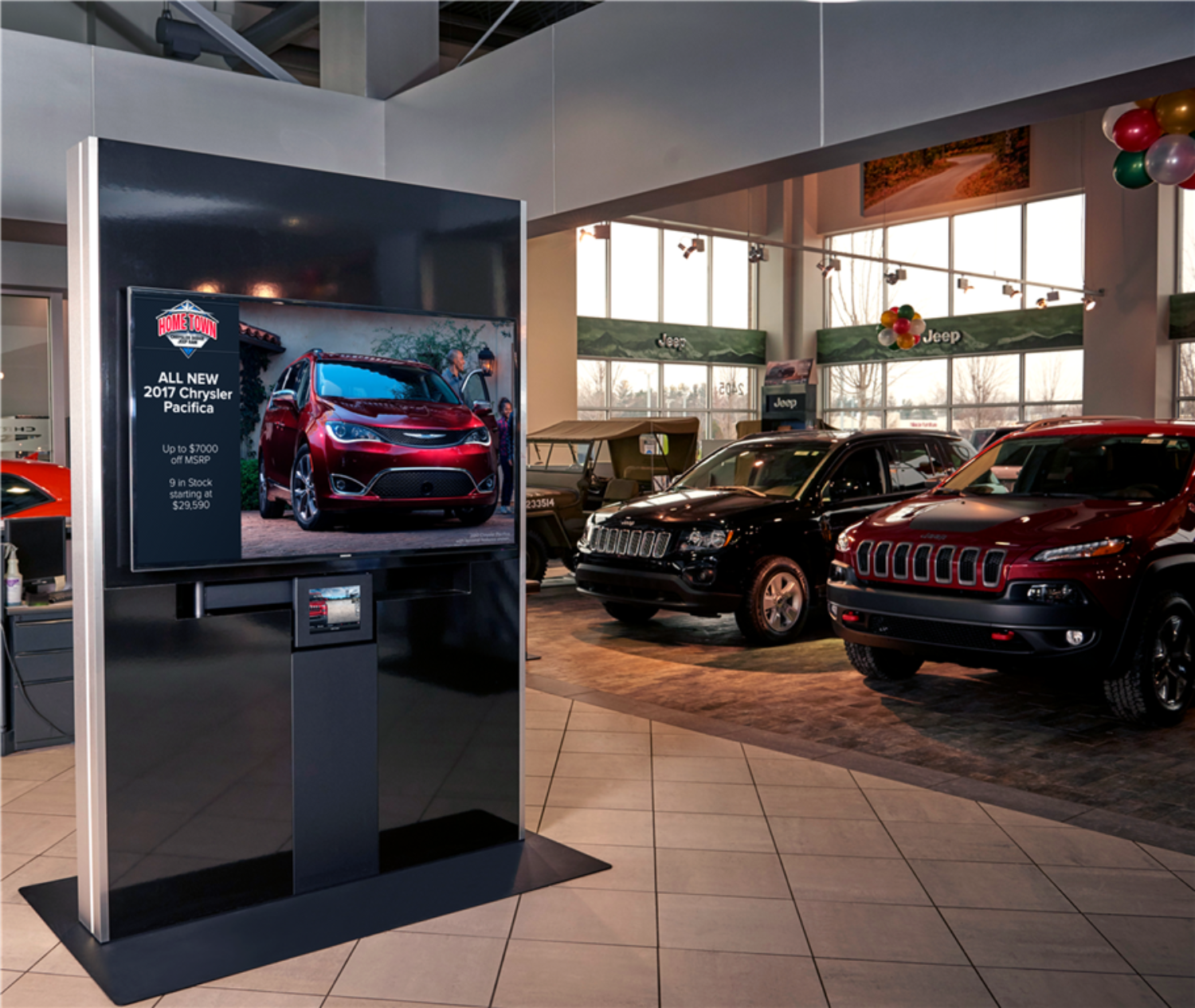 automotive kiosk in a showroom with vehicles behind