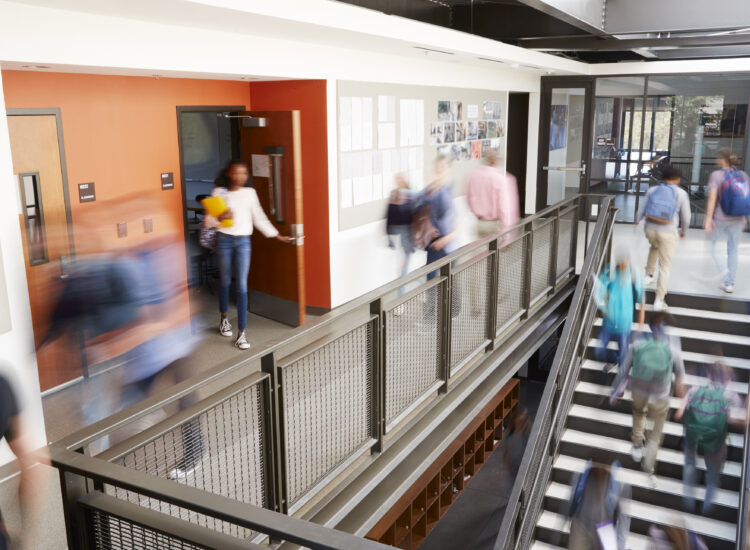 students moving through a college campus stairwell